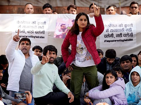 Wrestler Vinesh Phogat (red jacket), Tokyo Olympics medallist Bajrang Punia (second left), and other wrestlers participate in a protest against Wrestling Federation of India President Brijbhushan Sharan Singh and other officials in New Delhi, India, on January 20, 2023. They accused the federation president and coaches of sexually and mentally harassing young wrestlers.