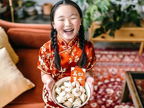 Fortune cookies with good wishes sealed in it and a red envelope with money in it are sometimes given to guests in the US, as part of Chinese New Year celebrations