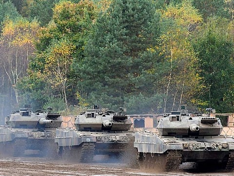 This file photo taken on October 13, 2017 shows an armored unit with Leopard 2 A7 main battle tanks of the German armed forces Bundeswehr driving through the mud in the context of an informative educational practice "Land Operation Exercise 2017" at the military training area in Munster, northern Germany.