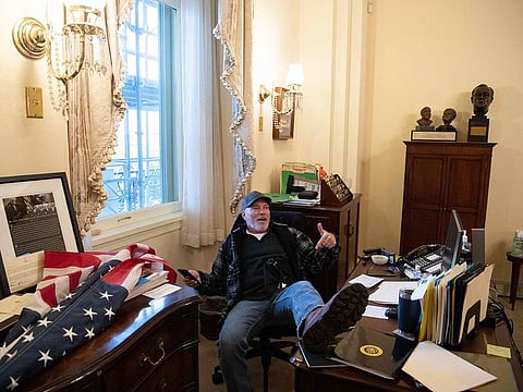 Richard Barnett with his feet on a desk in House speaker Nancy Pelosi's office.