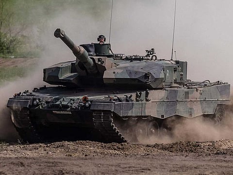 This picture taken on May 19, 2022 shows soldiers on a Polish Leopard tank as troops from Poland, USA, France and Sweden take part in the DEFENDER-Europe 22 military exercise, in Nowogard, Poland.