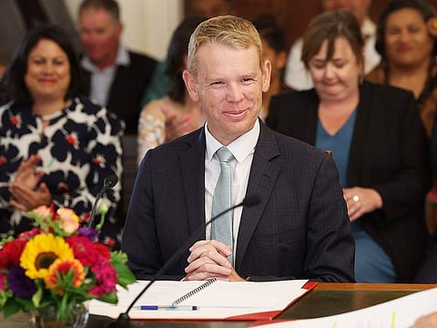 New Zealand's new Prime Minister Chris Hipkins smiles as he is sworn in by Governor General Dame Cindy Kiro during a ceremony at The Government House in Wellington on January 25, 2023.