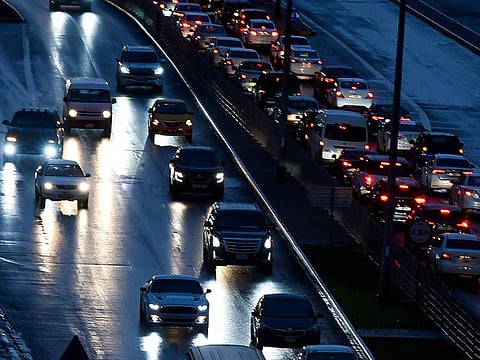 Motorists during the early morning rain on Khalidiya Street in Sharjah on Wednesday.