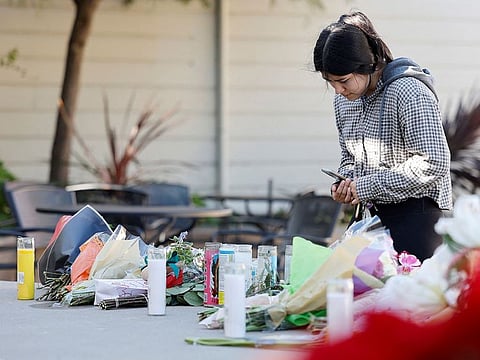 Half Moon Bay resident Susana Gutierrez visits a memorial for shooting victims at Mac Dutra Park in Half Moon Bay, California.