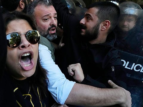 Anti-government protesters scuffle with riot police outside the ministry of Justice, in Beirut, Lebanon, on January 26, 2023.