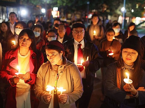 People hold candles during a candlelight vigil for the victims of the recent mass shootings in Monterey Park and Half Moon Bay on Thursday, January 26, 2023 in San Francisco, California. Hundreds of people attended a candlelight vigil to honour the victims of back-to-back mass shootings in northern and southern California this past week.