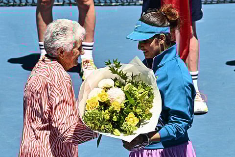 India's Sania Mirza (right) receives a bouquet during the awards ceremony after losing in her final grand slam match in Melbourne on Friday.