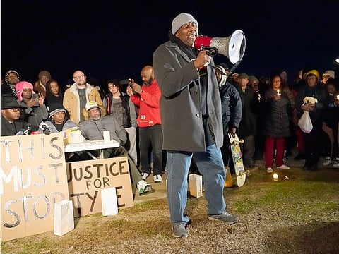 Rev. Andre E Johnson, of the Gifts of Life Ministries, preaches at a candlelight vigil for Tyre Nichols, who died after being beaten by Memphis police officers, in Memphis, on Thursday, January 26, 2023. Behind at left are Tyre's mother RowVaughn Wells and his stepfather Rodney Wells.