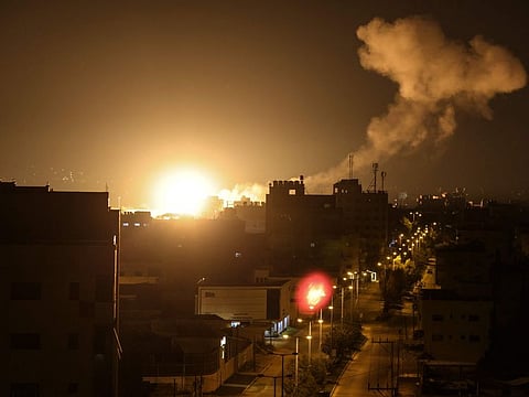 Fire and smoke rise above buildings in Gaza City as Israel launched air strikes on the Palestinian enclave early on January 27, 2023.