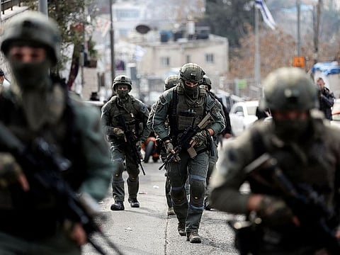 Israeli security personnel work at a scene where a suspected incident of shooting attack took place, police spokesman said, just outside Jerusalem's Old City.