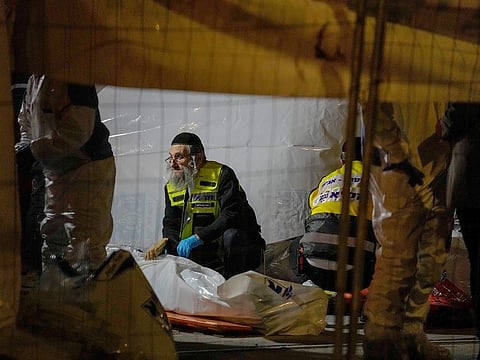 Members of Zaka Rescue and Recovery team check victims of a shooting attack near a synagogue in Jerusalem, on Friday, January 27, 2023.