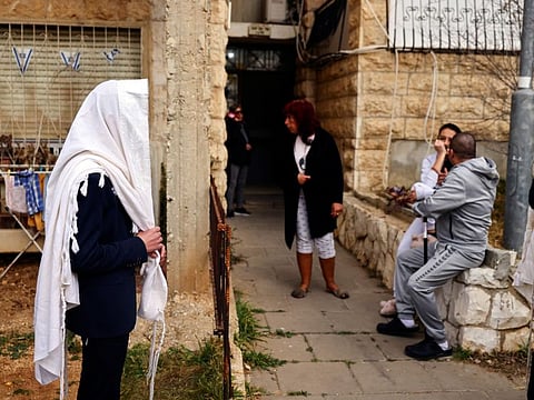 Israelis gather near the scene of a shooting attack in Neve Yaacov on January 28, 2023.