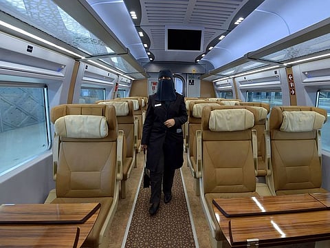 Saudi conductor Tharaa Ali in one of the wagons of a high-speed train ferrying pilgrims to Mecca. The transportation fee at the holy sites for the pilgrims uncovered by the Mashaer Train service has been cut to SR300 instead of SR400.