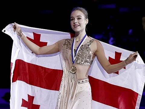 Gold medallist Georgia's Anastasiia Gubanova celebrates on the podium after winning the women's free skating
