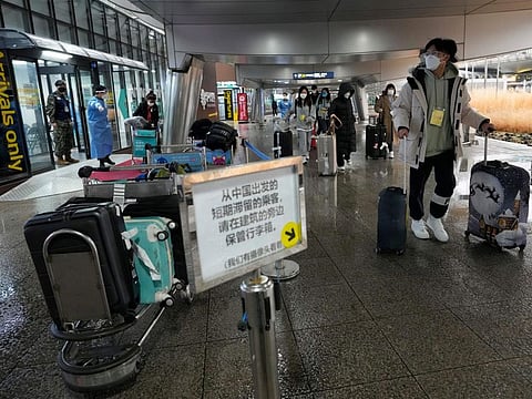 Passengers coming from China pass by a COVID-19 testing center at the Incheon International Airport in Incheon, South Korea, on Jan. 14, 2023. South Korea says it will continue to restrict the entry of short-term travelers from China through the end of February over concerns that the spread of COVID-19 in that country may worsen following the Lunar New Year’s holidays. (AP Photo/Ahn Young-joon)