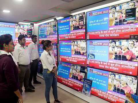 People watch a live telecast of Union Budget 2023-24 presentation at an electronic showroom, in Kolkata, India