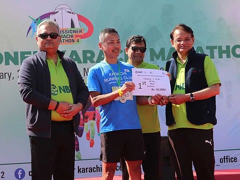 A winner being given a prize at the end of the Karachi marathon.