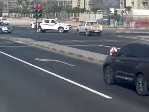A still from a police video showing the moment before a crash caused by a pick-up jumping a red light in Sharjah
