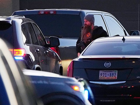A Las Vegas police officer stands near the home of former actor Nathan Lee Chasing His Horse, who goes by Nathan Chasing Horse, on Tuesday, in North Las Vegas. Authorities raided the home of the former actor Tuesday in connection with a sexual assault investigation.