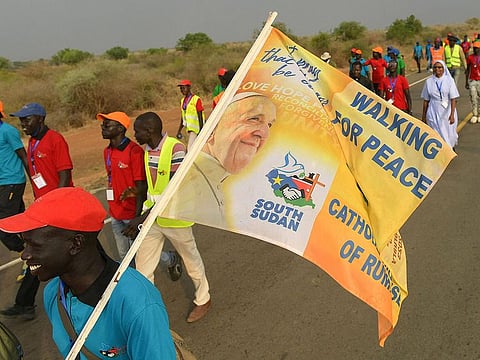 About 60 youth and spiritual leaders reach Bori village on the outskirts of Juba, on February 2, 2023 after walking most of the way from the central town of Rumbek, a journey of some 400 kilometres, for peace ahead of Pope Francis' visit to South Sudan from February 3 to 5, 2023.