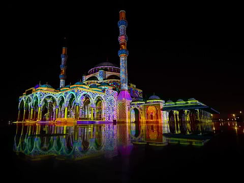 A mosque in Sharjah lights up in bright colours during the 2022 Light Festival