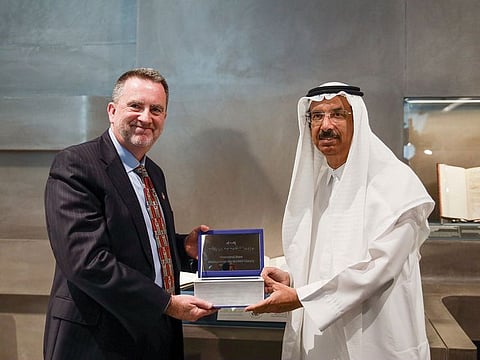 Sean Murphy presents a rare copy of the Holy Quran to Mohammad Ahmad Al Murr on during the Emirates Airline Festival of Literature in Dubai on Thursday.