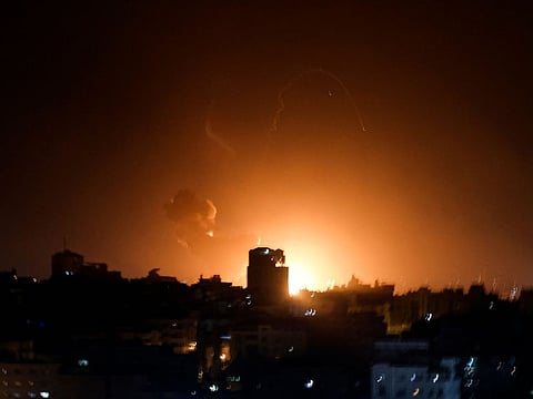 Fire and smoke rise above buildings in Gaza City as Israel launched air strikes on the Palestinian enclave early on February 2, 2023.
