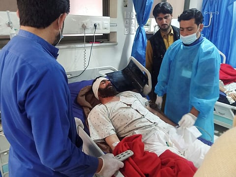 A man, who was injured after a suicide blast in a mosque, receives medical aid at a hospital in Peshawar.