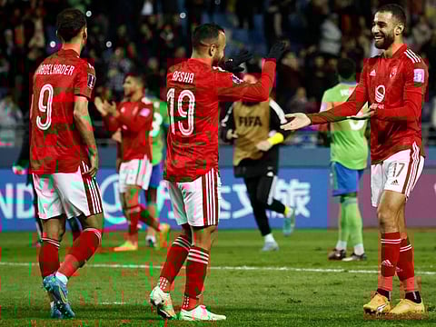 Al Ahly's forward Ahmed Abdel Kader (left), midfielder Mohamed Afsha (centre) and midfielder Amr el-Solia celebrate winning the FIFA Club World Cup second round match against Seattle Sounders FC at the Ibn Batouta Stadium in Tangier.