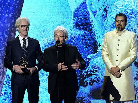 (L-R) US drummer and composer Stewart Copeland, record producer Herbert Waltl, and Indian composer Ricky Kej accept the award for Best Immersive Audio Album during the pre-telecast show of the 65th Annual Grammy Awards at the Crypto.com Arena in Los Angeles.