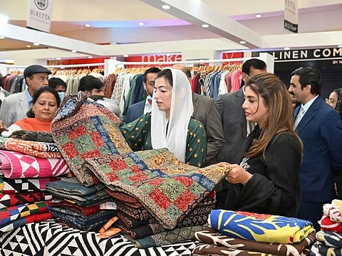 Aseefa Bhutto Zardari examines handicrafts on display at an exhibition in a Karachi mall.
