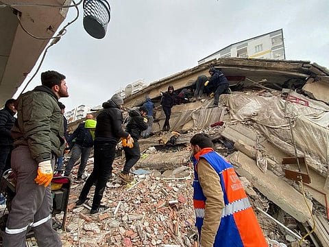 People search through rubble following an earthquake in Diyarbakir, Turkey, on February 6.