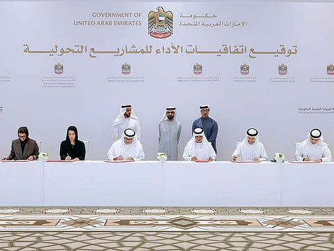 His Highness Sheikh Mohammed bin Rashid Al Maktoum (standing in centre) at the signing of the agreements