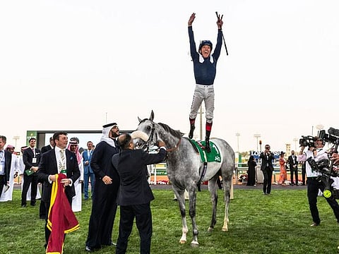 Frankie Dettori performing his traditional flying dismount after winning the 2020 stc 1351 Turf Sprint with Dark Power.