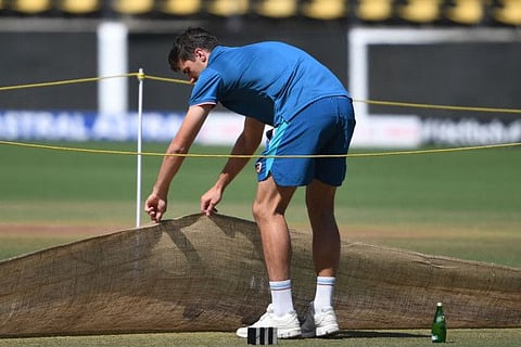 Australia's captain Pat Cummins inspects the pitch during a practice session at the Vidarbha Cricket Association (VCA) Stadium in Nagpur on the eve of the first Test.