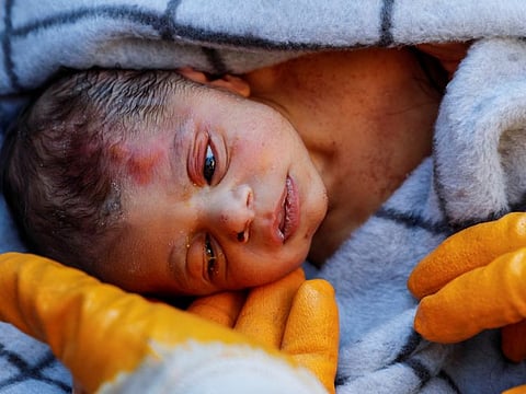 A rescuer holds baby boy Kerem Agirtas, a 20-day-old survivor who was pulled from under the rubble, in the aftermath of a deadly earthquake in Hatay, Turkey, February 8, 2023.