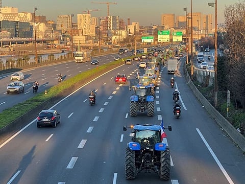 French farmers drive their tractors on the A4 motorway near Paris to gather in the French capital in protest at pesticide restrictions and other environmental regulations they say are threatening agricultural production, France, February 8, 2023.