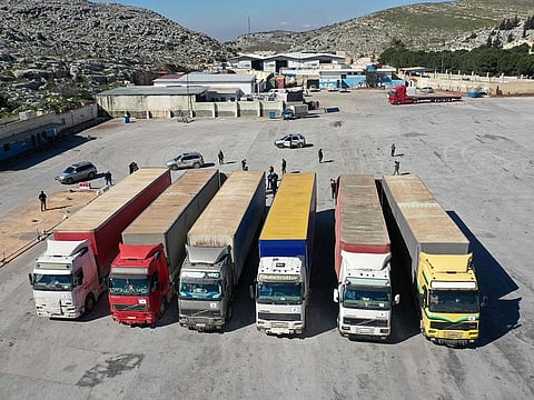 Trucks carrying humanitarian aid arrive in Syria after crossing the Bab Al Hawa border with Turkey on February 9, 2023.