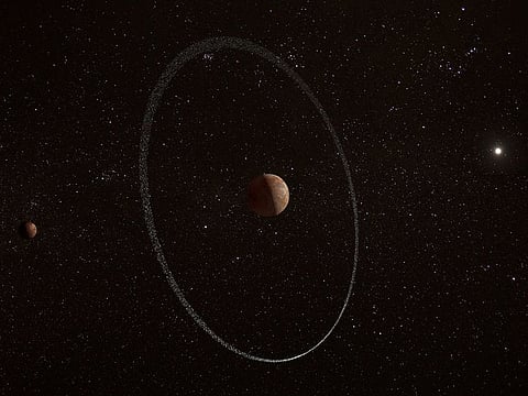 An illustration showing the frigid distant world Quaoar, orbiting in our solar system beyond Pluto, surrounded by its newly discovered ring, along with its moon Weywot.