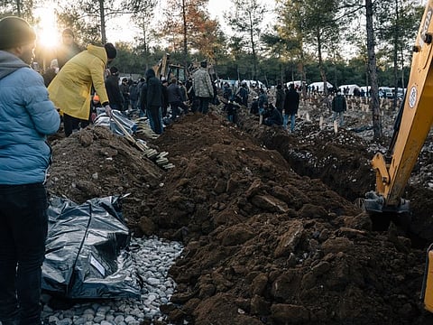 People gather for burial of earthquake victims at a makeshift cemetery on the outskirts of Kahramanmaras, Turkey, on Thursday. MUST CREDIT: Photo for The Washington Post by Alice Martins
