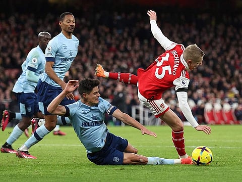 Arsenal's Oleksandr Zinchenko is fouled by Brentford's Christian Norgaard