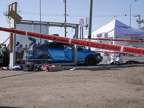 Members of Rescue and Recovery team work at the site of a car-ramming attack at a bus stop in Ramot, in east Jerusalem, Friday, Feb. 10, 2023.