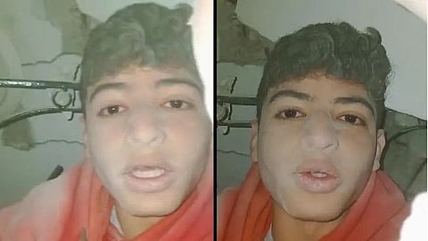 The boy under the rubble of his home.