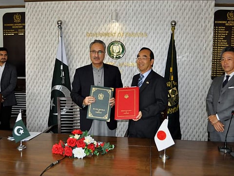 Japan Ambassador Wada Mitsuhiro exchanging documents with Secretary of Economic Affairs Division Dr Kazim Niaz at MoU signing ceremony.