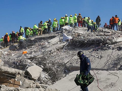 Rescuers search for survivors among destroyed buildings in Nurdagi.
