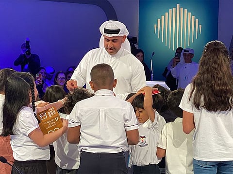 Abdulla Lootah distributing shopping vouchers to young SDG ambassadors in Dubai on Sunday.