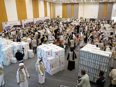 Volunteers pack relief items for Turkey and Syria at ADNEC on Saturday