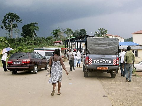 People wait to cross the border into Equatorial Guinea by car and by foot in Kye-Ossi, Cameroon, May 23, 2015