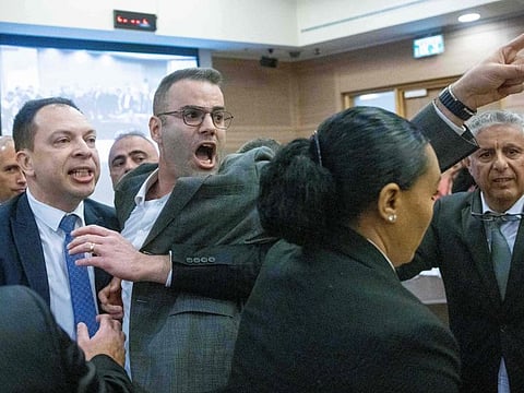 Israeli lawmakers Vladimir Bilyak (L) and Yorai Lahav (C) of the Yesh Atid opposition party, protest inside the Knesset on February 13, 2023 against controversial legal reforms being touted by the country's hard-right government. AFP