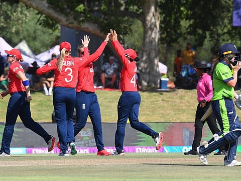 Ireland's Gaby Lewis (right) walks back to the pavilion as England players celebrate her dismissal during the Group B T20 women's World Cup cricket match at Boland Park in Paarl.